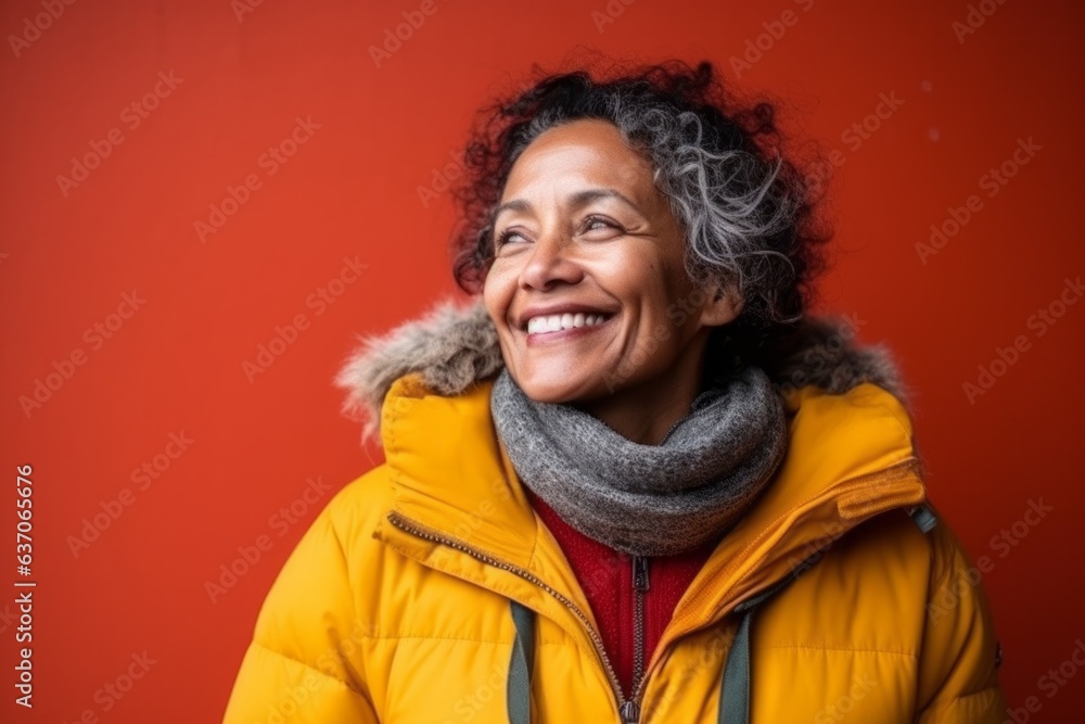 Portrait of a smiling african american woman in winter clothes on a red background Portrait of a smiling african american woman in winter clothes on a red background