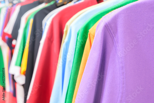 Fashion clothes on clothing rack - bright colorful closet. Closeup of rainbow color choice of trendy female wear on hangers in store closet or spring cleaning concept. Summer wardrobe. sweatshirts