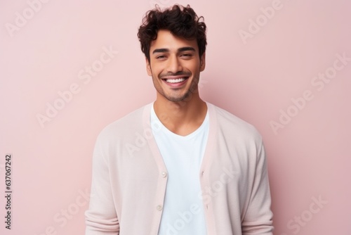 Portrait of a handsome young man smiling at camera against pink background © Leon Waltz