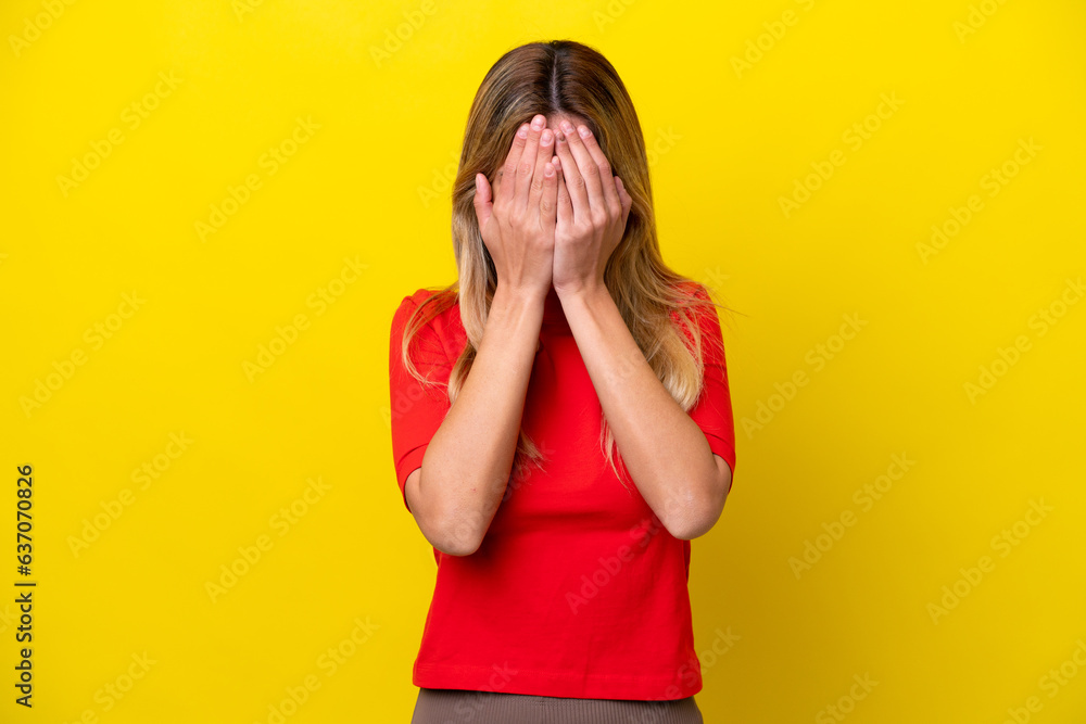 Young Uruguayan woman isolated on yellow background with tired and sick expression Young Uruguayan woman isolated on yellow background with tired and sick expression
