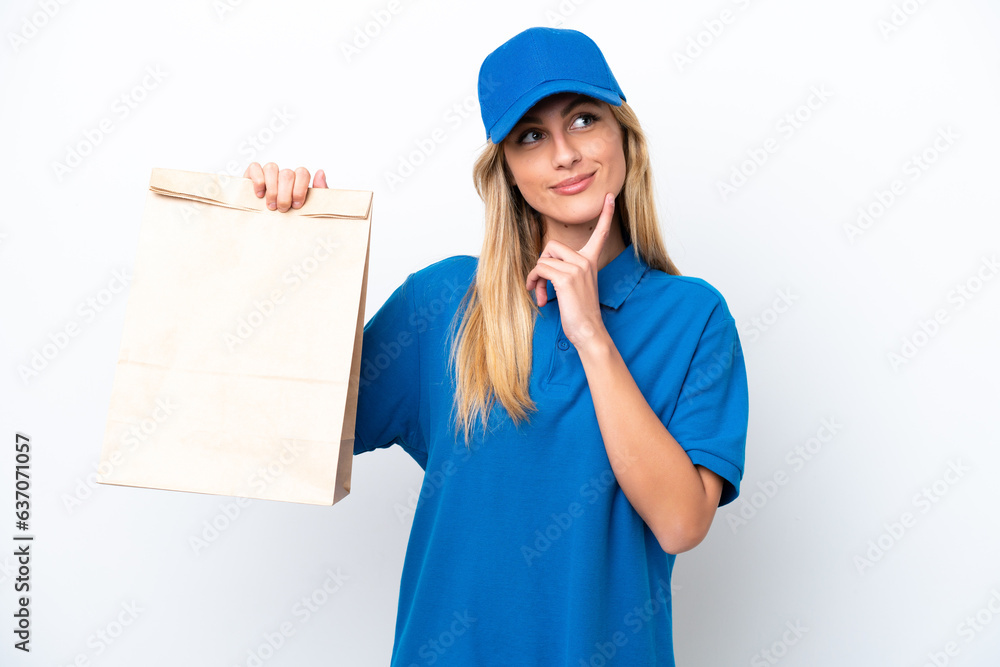 Young Uruguayan woman taking a bag of takeaway food isolated on white background thinking an idea while looking up Young Uruguayan woman taking a bag of takeaway food isolated on white background thinking an idea while looking up