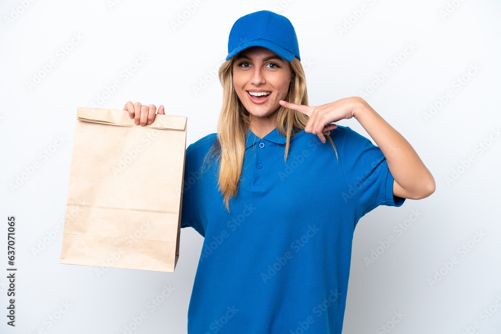 Young Uruguayan woman taking a bag of takeaway food isolated on white background giving a thumbs up gesture Young Uruguayan woman taking a bag of takeaway food isolated on white background giving a thumbs up gesture