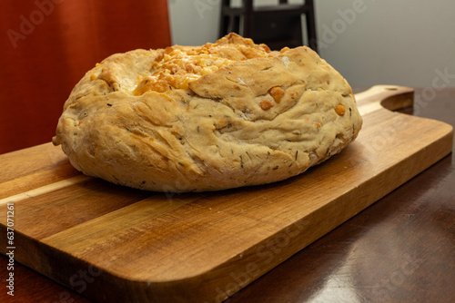 Freshly Baked Homemade Asiago Cheese Bread on a Cutting Board 