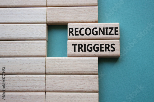 Recognize triggers symbol. Concept words Recognize triggers on wooden blocks. Beautiful grey green background. Business and Recognize triggers concept. Copy space.