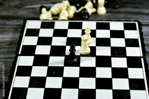 Chess, a board game for two players, called white and black, each controlling an army of chess pieces in their color, the objective to checkmate the opponent's king, strategy and success concept