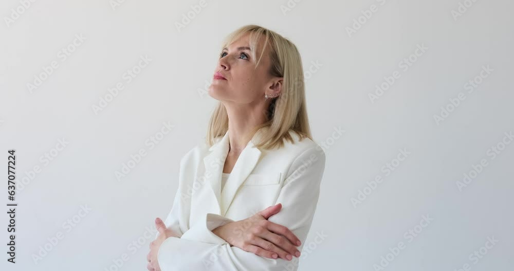 Sad Caucasian woman on a clean white backdrop. Her downcast eyes and somber expression reflect her feelings of sadness and melancholy. The simplicity of the white background accentuates her emotions. Sad Caucasian woman on a clean white backdrop. Her downcast eyes and somber expression reflect her feelings of sadness and melancholy. The simplicity of the white background accentuates her emotions.