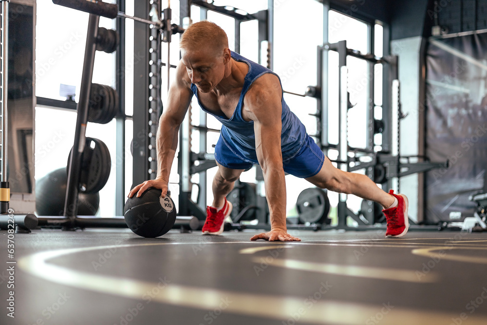 Fit man doing push ups on medicine ball at the gym. Fit man doing push ups on medicine ball at the gym.