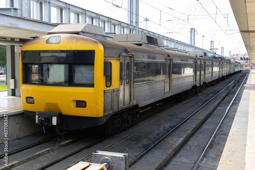 One switched-off train with yellow front cabin stands on the rails in the depot