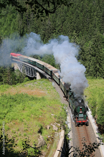 A steam locomotive driving through the Krkonoše hills