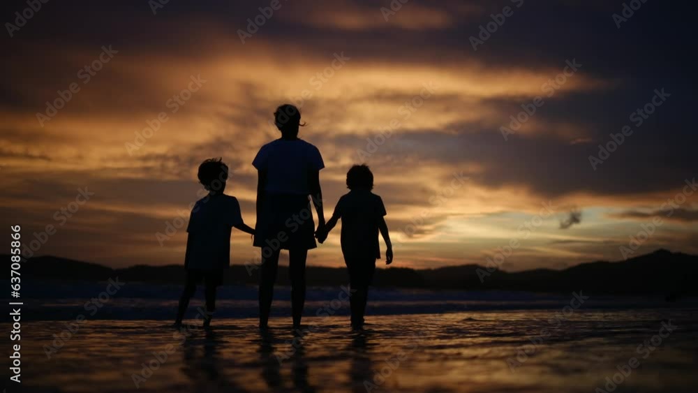 happy family. mother and kids by the sea at sunset silhouette. mother and child kids reach out to the sun. kid dream concept. happy family little kids and dad alone with nature relax sunset concept happy family. mother and kids by the sea at sunset silhouette. mother and child kids reach out to the sun. kid dream concept. happy family little kids and dad alone with nature relax sunset concept