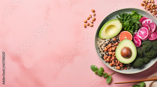 Foto Vegan Buddha or poke bowl salad with buckwheat, vegetables and seeds on pink bac