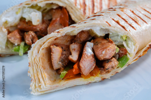 traditional kebeb on a roll sandwich tortilla white chicken and onion