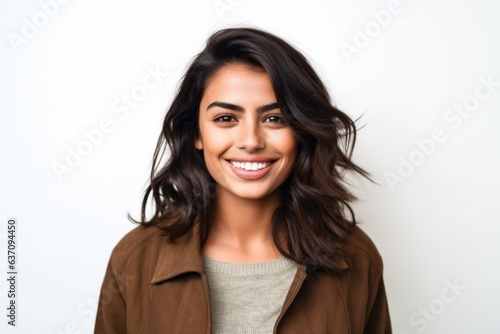 Medium shot portrait of an Indian woman in her 20s against a white background