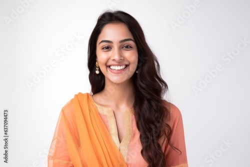 Obraz na płótnie Medium shot portrait of an Indian woman in her 20s wearing salwar kameez against a white background w salonie