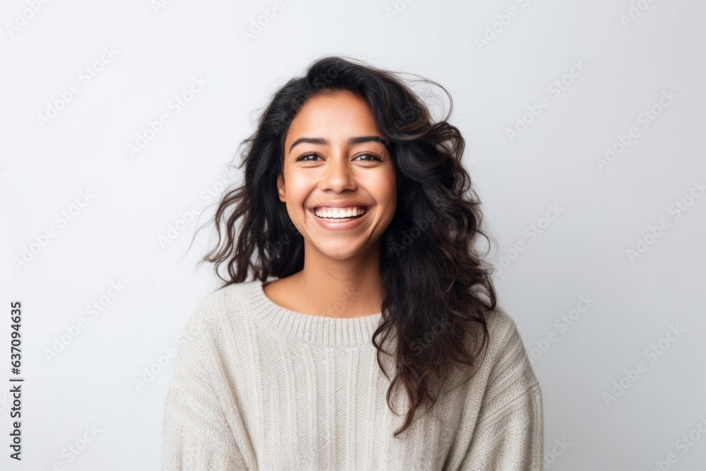 Lifestyle portrait of an Indian woman in her 30s against a white background Lifestyle portrait of an Indian woman in her 30s against a white background