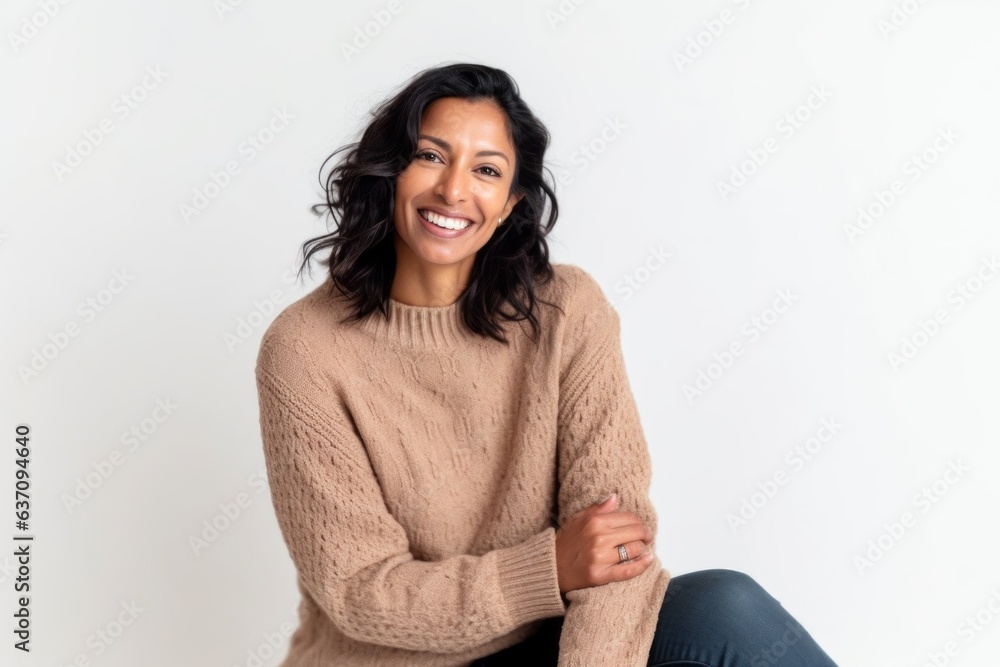 Lifestyle portrait of an Indian woman in her 30s against a white background Lifestyle portrait of an Indian woman in her 30s against a white background
