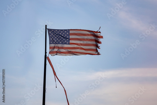 A Weathered and Torn American Flag blowing in the wind