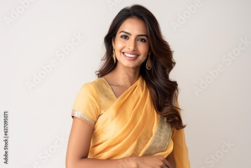Obraz na płótnie Medium shot portrait of an Indian woman in her 30s wearing traditional sari against a white background w salonie