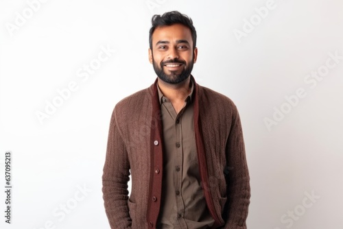 Medium shot portrait of an Indian man in his 30s against a white background © Eber Braun