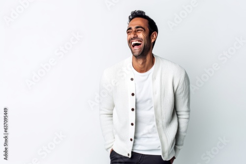 Lifestyle portrait of an Indian man in his 30s against a white background