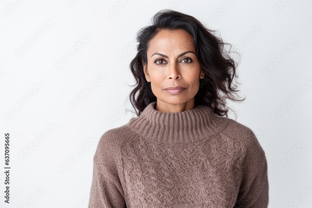 Lifestyle portrait of an Indian woman in her 40s against a white background Lifestyle portrait of an Indian woman in her 40s against a white background
