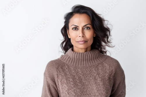 Lifestyle portrait of an Indian woman in her 40s against a white background © Eber Braun