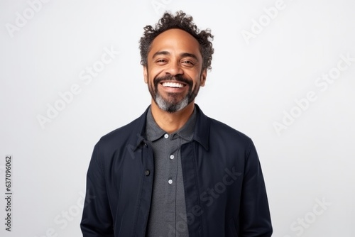 Medium shot portrait of an Indian man in his 40s against a white background