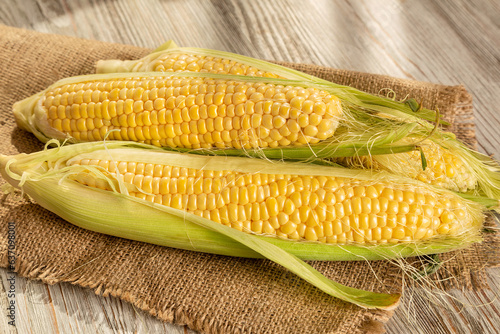 Ripe corncobs on a wooden background