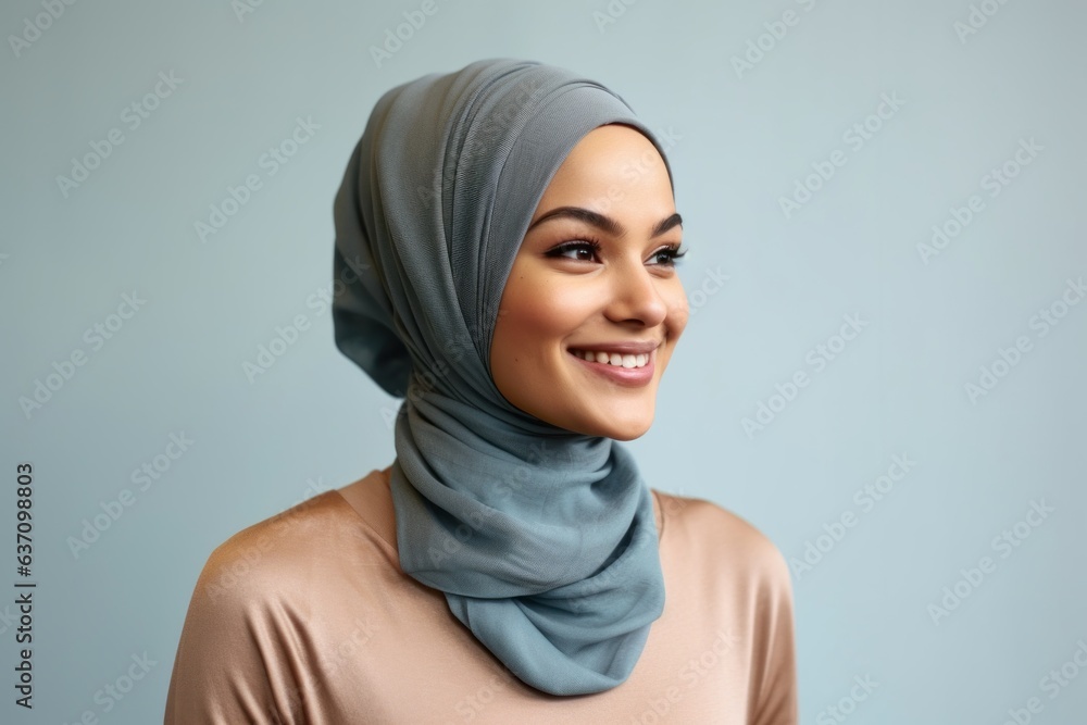 Lifestyle portrait of an Indian woman in her 30s wearing hijab in a minimalist background Lifestyle portrait of an Indian woman in her 30s wearing hijab in a minimalist background
