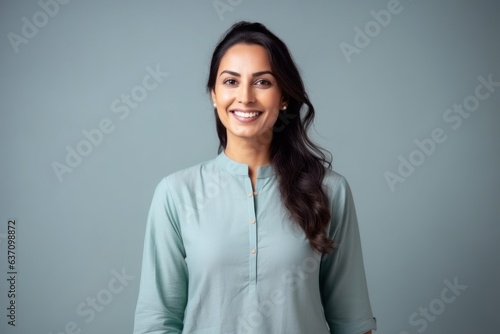 Obraz na płótnie Medium shot portrait of an Indian woman in her 30s wearing salwar kameez in a minimalist background w salonie