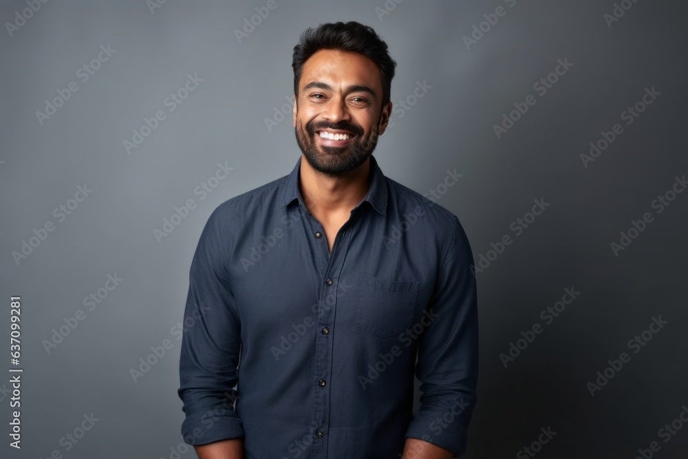 Medium shot portrait of an Indian man in his 30s in a minimalist background Medium shot portrait of an Indian man in his 30s in a minimalist background