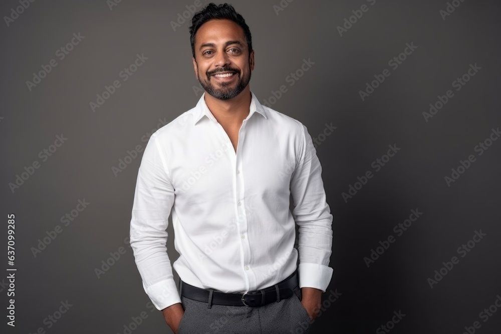 Medium shot portrait of an Indian man in his 30s in a minimalist background Medium shot portrait of an Indian man in his 30s in a minimalist background