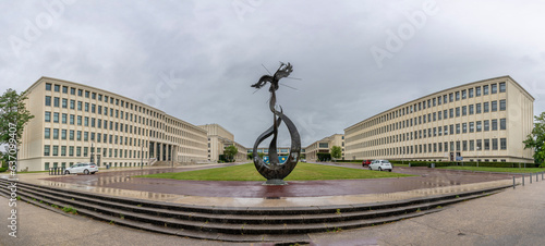 Fototapeta Naklejka Na Ścianę i Meble -  Caen, France - 07 27 2023: View of the campus University of Caen Normandy, the buildings building and the sculpture the phoenix from Esplanade of Peace.
