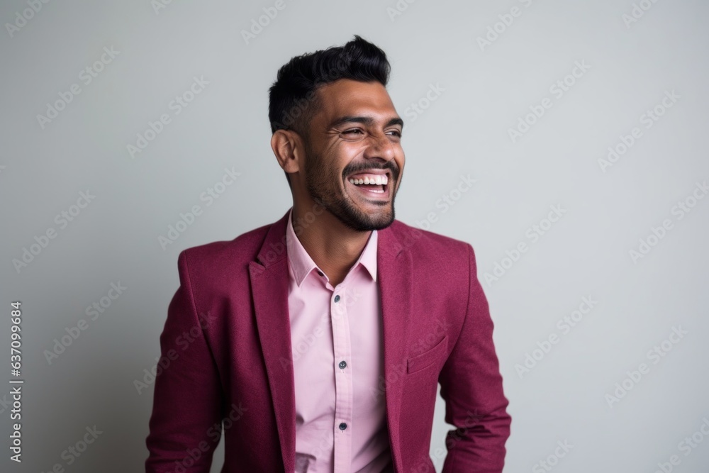 Lifestyle portrait of an Indian man in his 30s in a minimalist background Lifestyle portrait of an Indian man in his 30s in a minimalist background