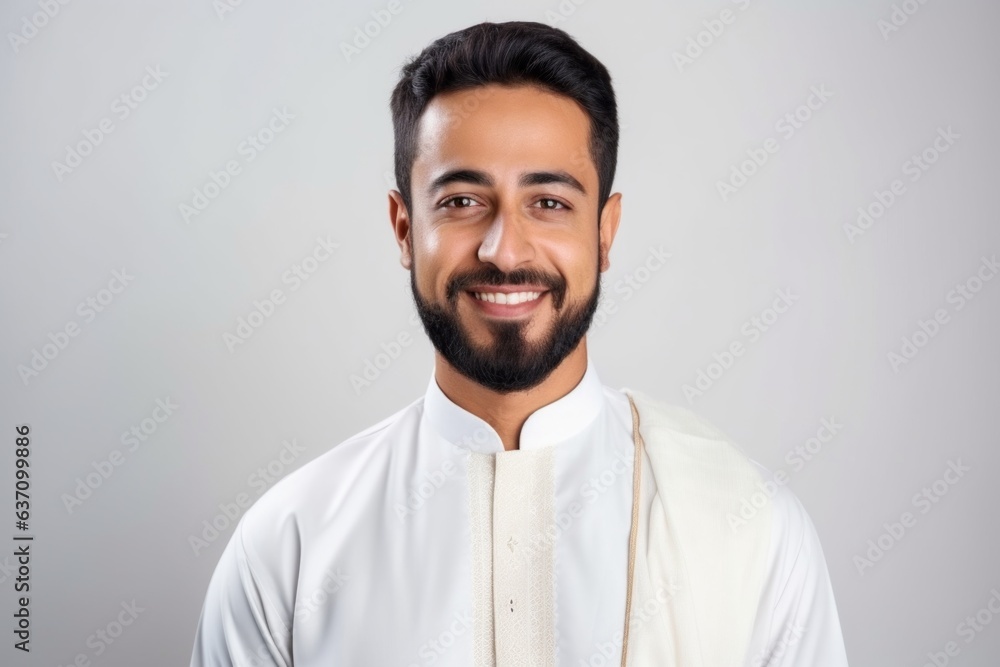 Medium shot portrait of an Indian man in his 30s wearing hijab in a minimalist background Medium shot portrait of an Indian man in his 30s wearing hijab in a minimalist background
