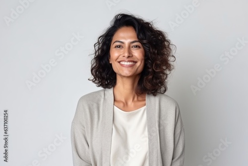Medium shot portrait of an Indian woman in her 40s in a minimalist background