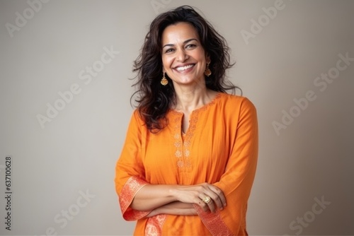 Obraz na płótnie Medium shot portrait of an Indian woman in her 40s wearing salwar kameez in a minimalist background w salonie