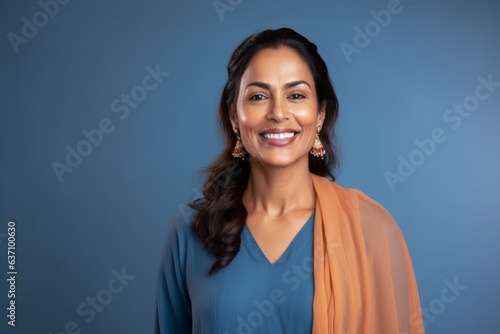 Obraz na płótnie Medium shot portrait of an Indian woman in her 40s wearing salwar kameez in a minimalist background w salonie