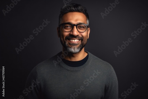 Lifestyle portrait of an Indian man in his 40s in a minimalist background