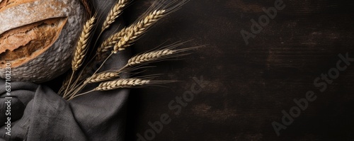Vászonkép different types of bread and wheat ears on wooden table background, flat lay, a