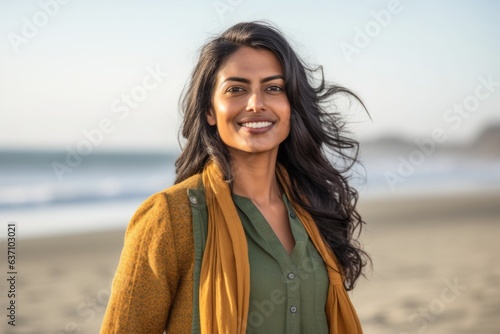 Lifestyle portrait of an Indian woman in her 30s in a beach 
