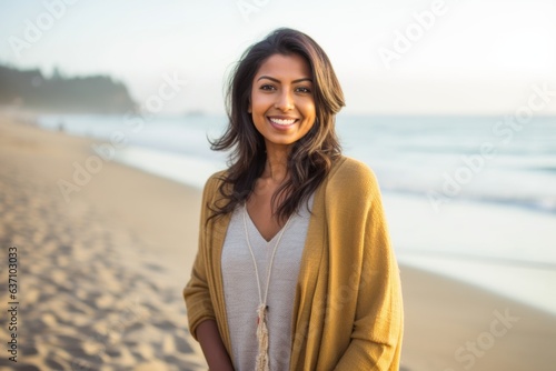 Lifestyle portrait of an Indian woman in her 30s in a beach 