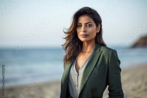 Lifestyle portrait of an Indian woman in her 30s wearing a sleek suit in a beach Free Download Lifestyle portrait of an Indian woman in her 30s wearing a sleek suit in a beach - GFXLoad