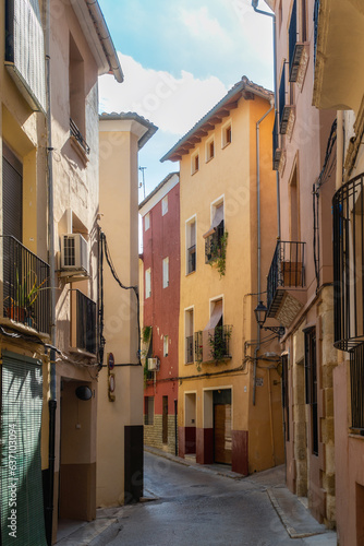 Alley in the old town with colorful buildings, in Xativa, Valencia (Spain)