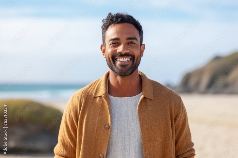 Medium shot portrait of an Indian man in his 30s in a beach Medium shot portrait of an Indian man in his 30s in a beach