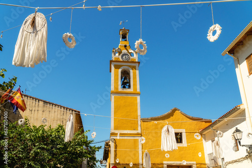 Beautiful church painted in yellow in Bellús town on a sunny day, Valencia (Spain)
