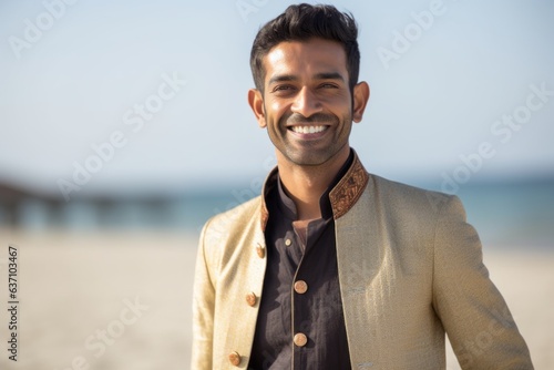 Group portrait of an Indian man in his 30s in a beach 