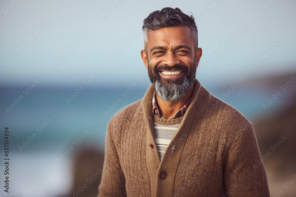 Portrait of smiling mature man at the beach on a sunny day Portrait of smiling mature man at the beach on a sunny day