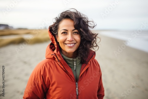 Portrait of smiling woman standing at beach on a cold winter day