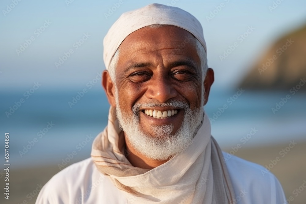 Portrait of happy mature muslim man smiling at camera on the beach Portrait of happy mature muslim man smiling at camera on the beach